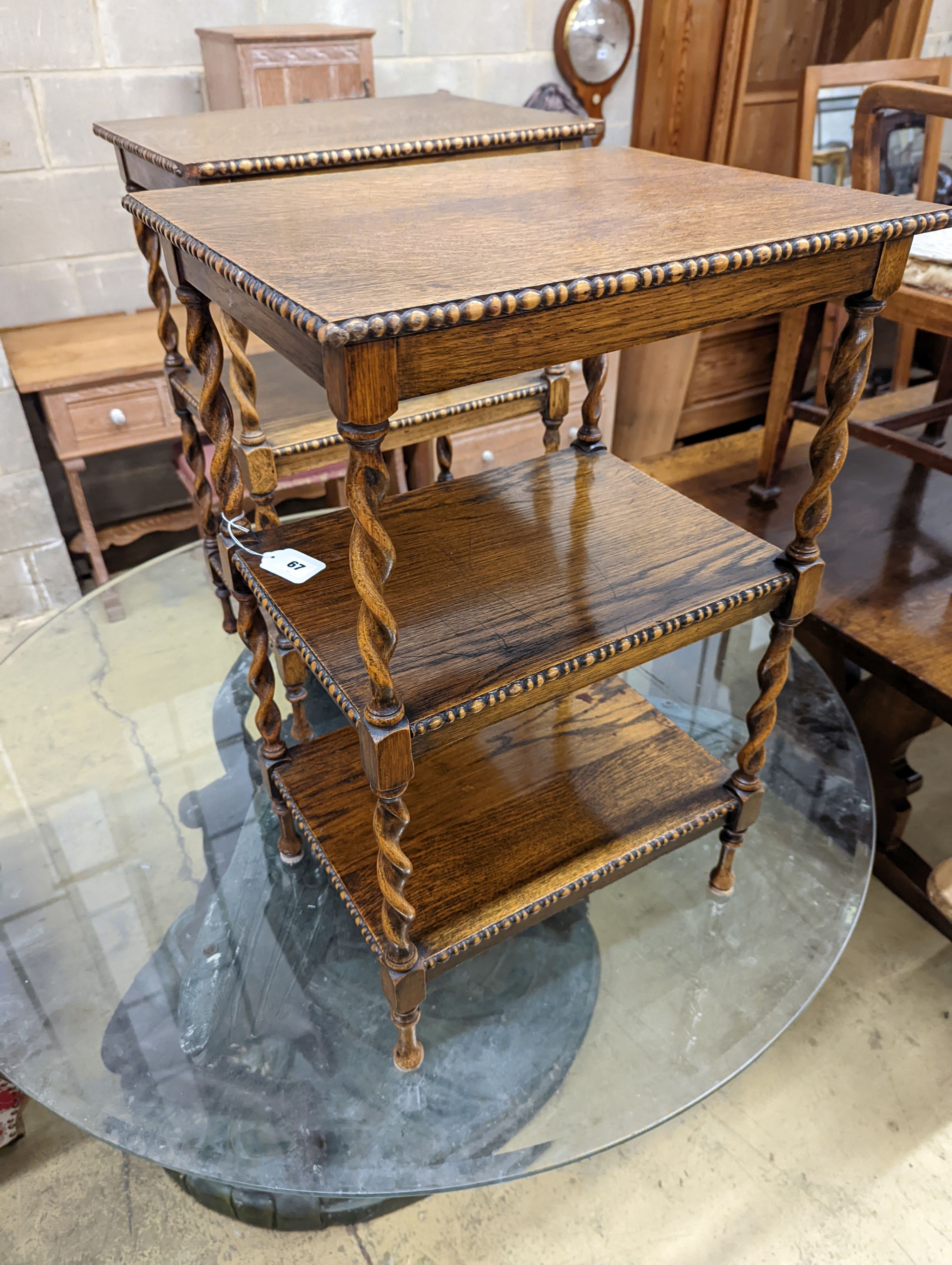 A pair of oak three-tier whatnots. W-46cm, D-36cm, H-69cm.